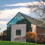 fall campus with stained glass on building