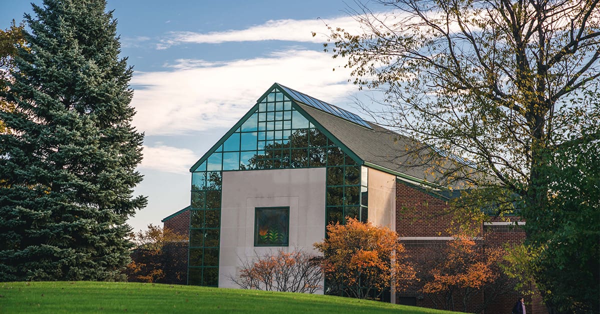 fall campus with stained glass on building